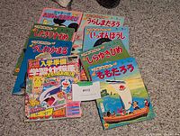 Group shot of Japanese picture books and magazine spread on carpet