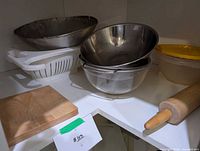 metal bowls, colander, container, cutting board, rolling pin