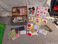 Full group shot showing origami papers, figurine, playing cards, craft items