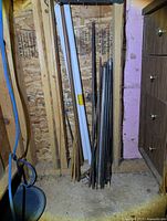 Round stock rods, copper pipe, fluorescent tube stored upright
