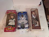Front view of all three boxed dolls