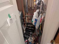 view into furnace room showing tool cases, socket sets, hanging pliers, bags