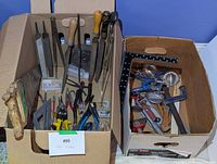Overall view of both cardboard boxes filled with assorted tools