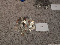 pile of mixed U.S. coins spread on carpet