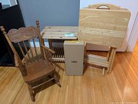 Group shot showing rocking chair, side table, boxed swing, TV trays
