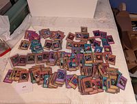 Wide view of large pile of Yu-Gi-Oh cards spread on surface