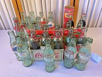 Overview of bottles, two carriers and promo tube on table