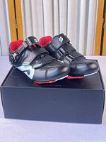 Pair of Peloton cycling shoes on box, full view