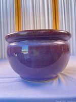 Front view of purple glazed ceramic planter