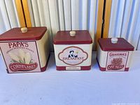 Front view of all three tin canisters