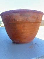 Side view showing ribbed terracotta pot surface