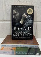 Stack of three paperback books showing spines and covers
