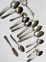 All 15 silver-plated pieces laid out for full view