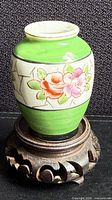 Front view of miniature porcelain vase on stand