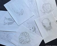 overview of all eight separate pencil sketches arrayed on surface