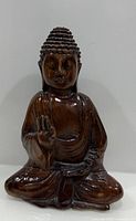Front view of carved wooden Buddha statue
