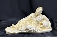 Front view of reclining scholar figurine showing overall form and details