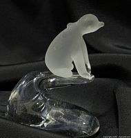 Front view of frosted polar bear on clear glass wave