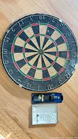 Front view of Accudart 501 dartboard with accessories visible