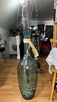 Full view of vase with branches and ribbon, floor setting