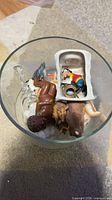 Assorted figurines placed inside clear glass compote