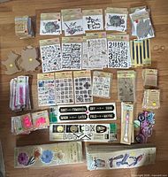 Full lot laid out showing all sealed packages of stickers, stamps, decals, chipboard, tools