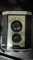 Front view showing twin lenses, model name, shutter lever, overall cosmetic condition