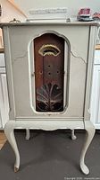 Full view of painted wooden radio cabinet on Queen Anne legs