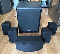 Front view of Velodyne subwoofer with five Polk Audio speakers