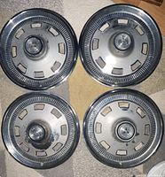 Top view of all four hubcaps showing overall design and wear
