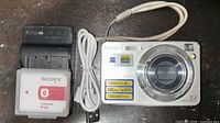Front view of camera with accessories charger battery cable