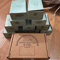 Stacked light green Spring Valley Scents inner boxes atop brown outer shipping box