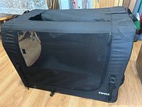 Side view of black Thule fabric dog crate showing large mesh panel and overall size