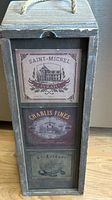 Front view showing decorative wine labels and sliding lid slot