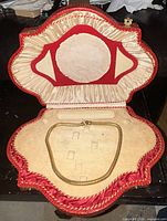 Necklace displayed inside red shaped presentation case
