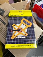 Front of boxed fiberglass measuring tape showing product image, length 30m/100ft