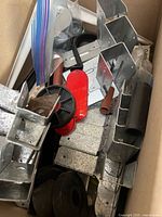 Top view of box showing variety of brackets, reflector, wheel hub, rubber pieces