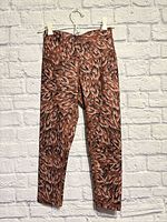 Front view of leggings showing abstract rust/brown print and 7/8 length
