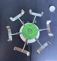 Top view showing full tester with six arms and green disc
