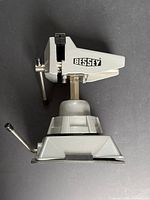 Side view of Bessey table top vise showing brand logo, pivot joint, base clamp lever