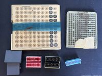 Overview showing beige compartment tray, grey tray, and four smaller holders