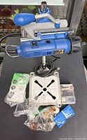 Rotary tool on stand with accessory bags and green accessory case