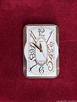 Front view showing rectangular white dial, brand logo, numerals, date scale