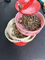 Full view of three-tier tray filled with assorted watch parts