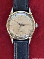 Front view of Crest wristwatch showing dial, hands, case and strap