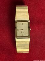 Front view showing gold-tone rectangular Lassale watch with integrated bracelet and dial details
