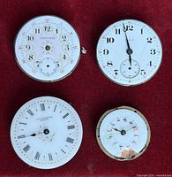 Four pocket watch movements on red background showing all dials