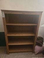 Front view of one bookcase showing shelves and overall design
