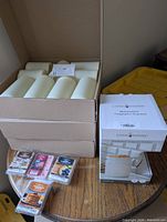 Stacked boxes with ivory flameless candles, four wax melt packs, boxed fragrance warmer