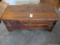 Closed cedar hope chest showing exterior wood grain and hardware